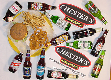 A spread of beer bottles around Chester's signs reading Best Burgers Both Sides of the Pecos